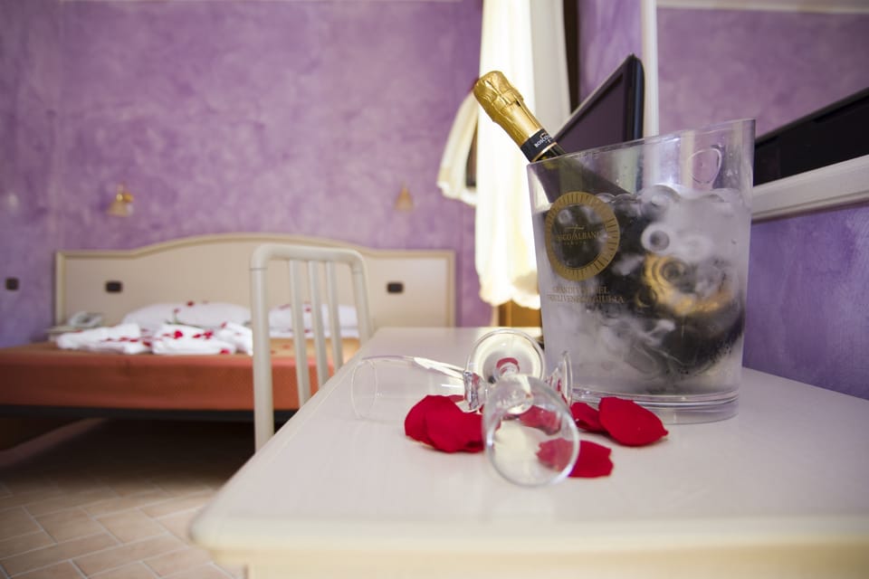 Junior Suite, Balcony, Pool View | Frette Italian sheets, premium bedding, down comforters, minibar