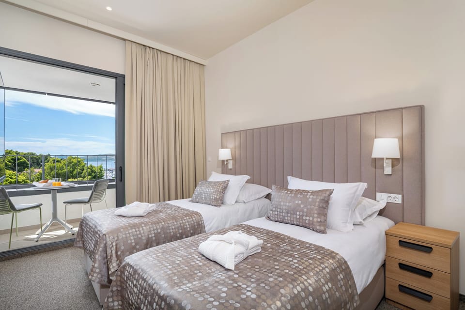 Deluxe Double or Twin Room, Balcony, Sea View | Minibar, in-room safe, desk, blackout drapes