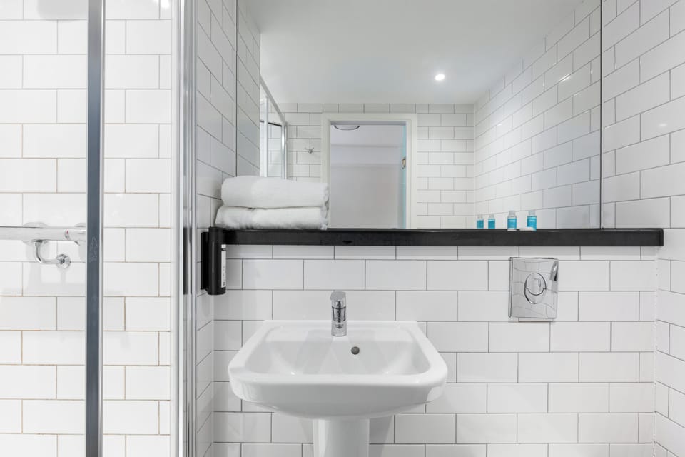 Shower, designer toiletries, hair dryer, towels