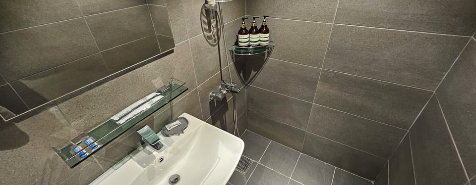 Standard Double Room | Bathroom | Shower, hair dryer, slippers, towels