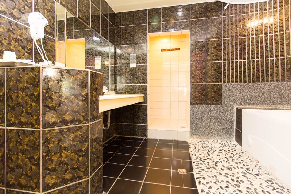 Separate tub and shower, free toiletries, hair dryer, slippers
