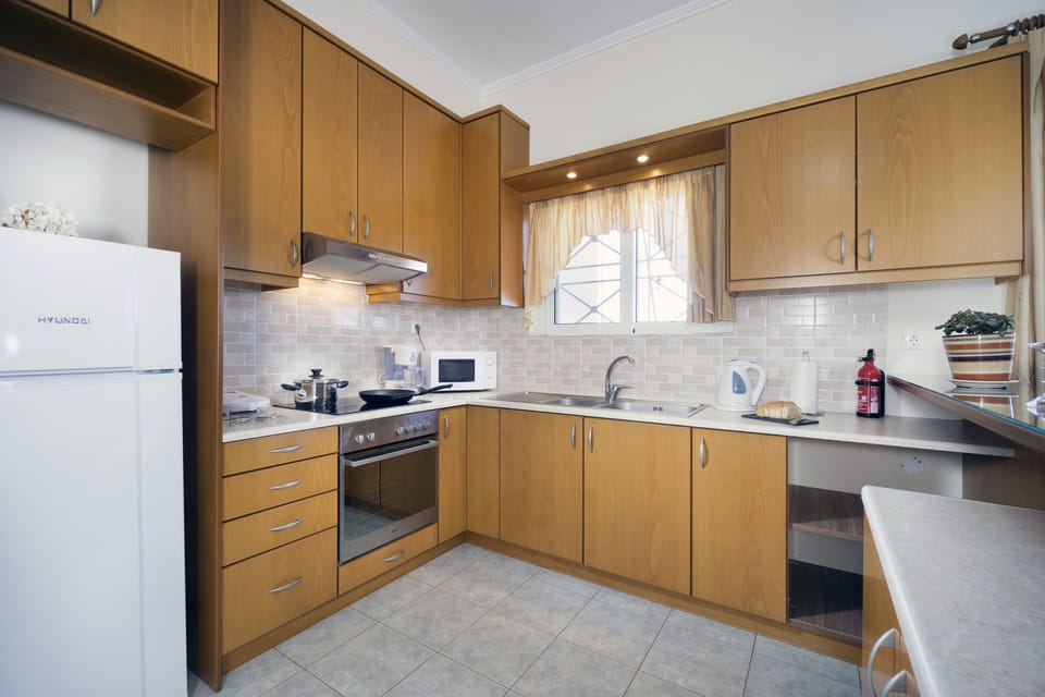Deluxe Apartment, 2 Bedrooms, Ground Floor | Private kitchen | Full-size fridge, microwave, oven, stovetop