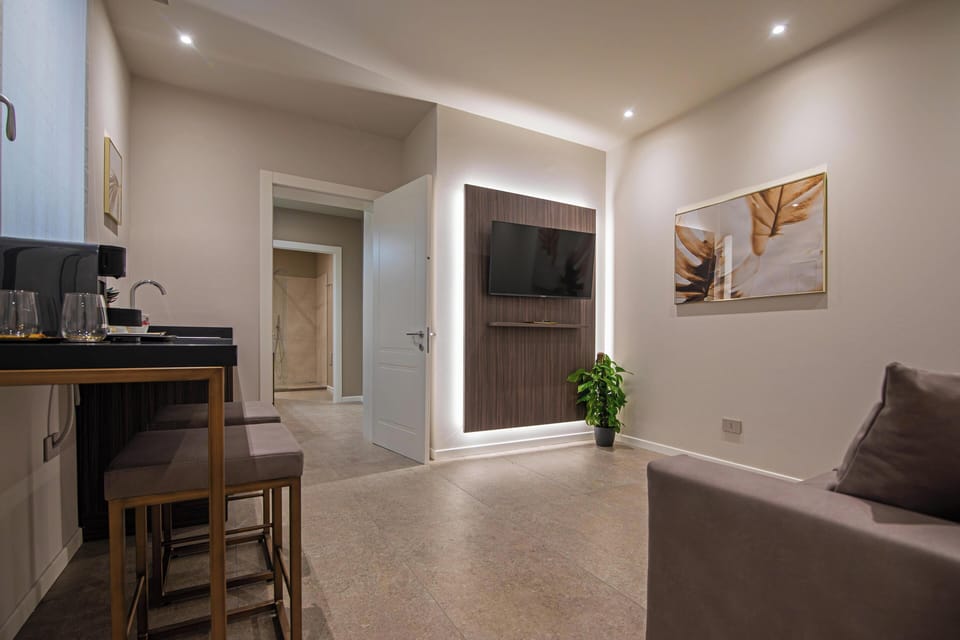 Luxury Suite | Living area | 43-inch LCD TV with satellite channels