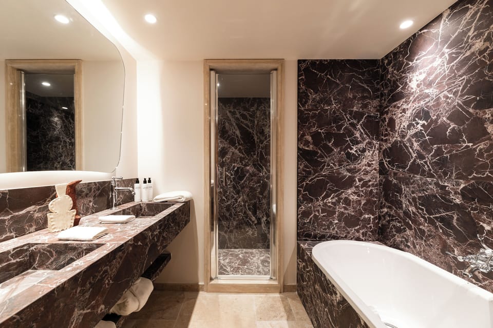 Deluxe Suite, Balcony, Mountain View | Bathroom | Hair dryer, bathrobes, slippers, towels