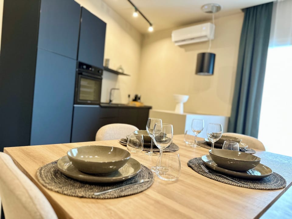 Deluxe Apartment | Living area | 30-inch flat-screen TV with digital channels