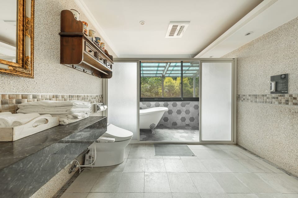 Two-Bedroom Suite | Bathroom | Hair dryer, slippers, towels, shampoo