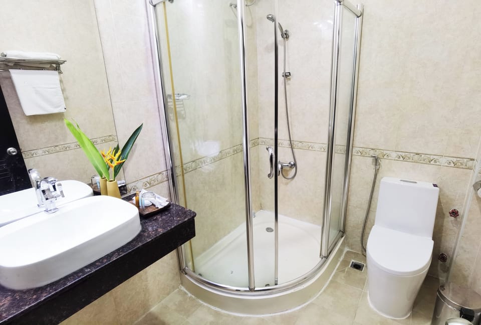 Shower, hair dryer, slippers, towels