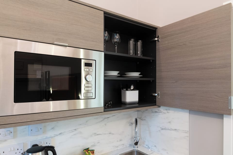 Microwave, electric kettle, cleaning supplies