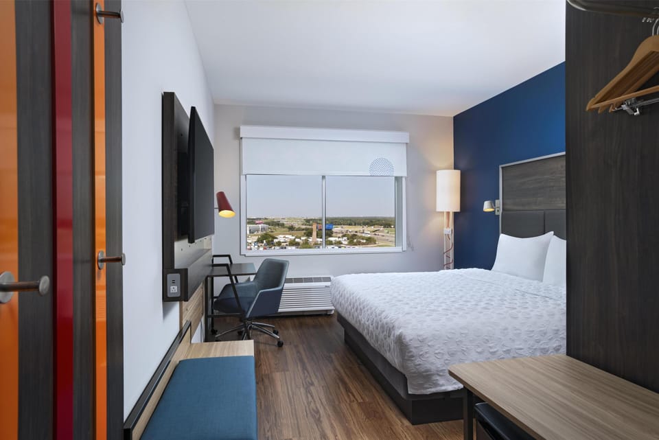 Premium bedding, desk, laptop workspace, blackout drapes