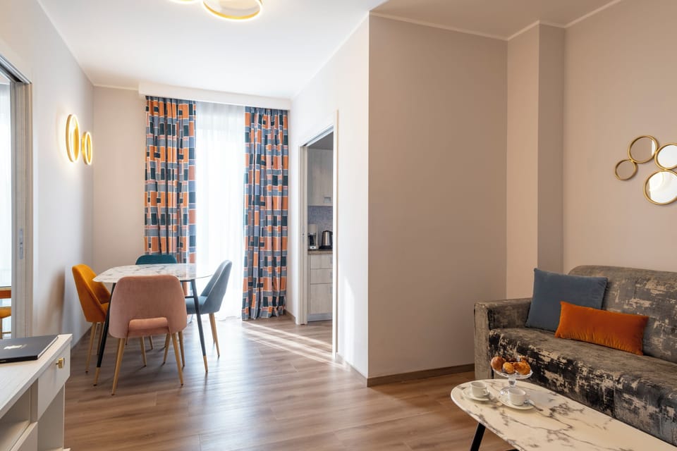 Deluxe Two-Room Apartment (2/3 Persons) with 1 sofa bed, partial lake view | Living area | 22-inch TV with satellite channels
