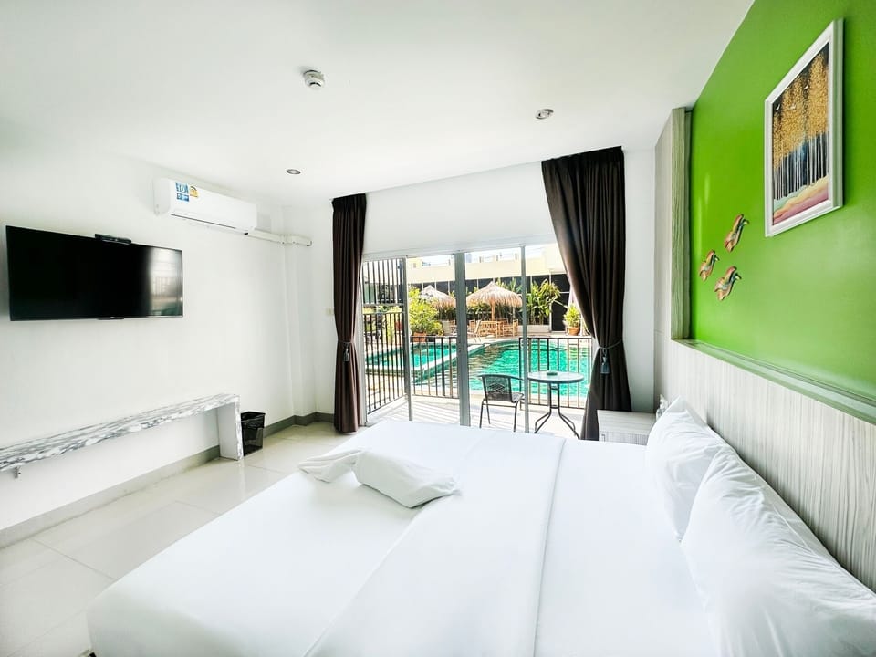Deluxe Room, Pool Access | Minibar, in-room safe, desk, free WiFi
