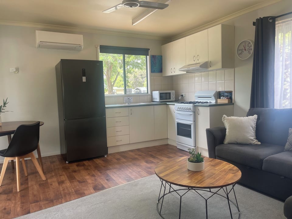 Deluxe Cabin, Balcony, Garden View | Living area | TV