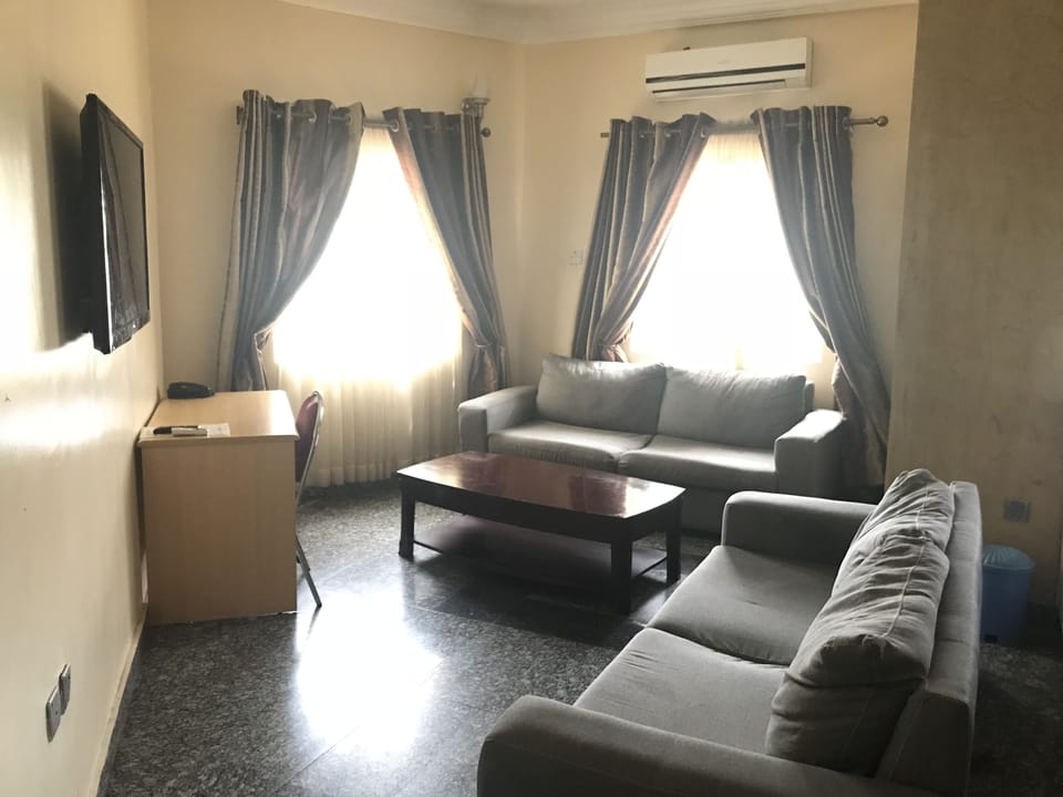 Luxury Room | Living area | 32-inch flat-screen TV with cable channels, TV
