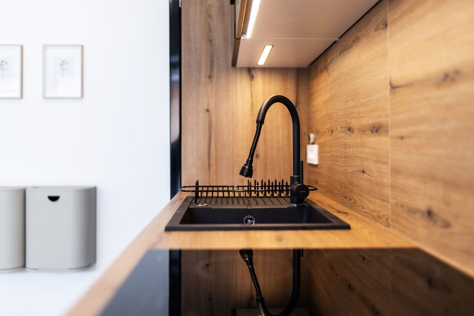Deluxe Apartment | Private kitchen | Coffee/tea maker, electric kettle, highchair, dining tables