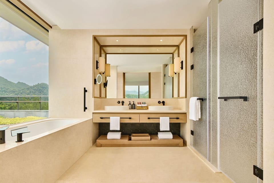 Deluxe Suite, 1 King Bed | Bathroom | Separate tub and shower, rainfall showerhead, free toiletries