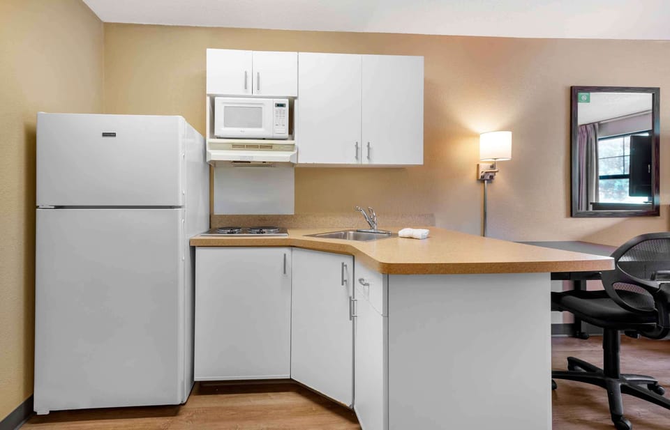 Desk, laptop workspace, blackout drapes, iron/ironing board