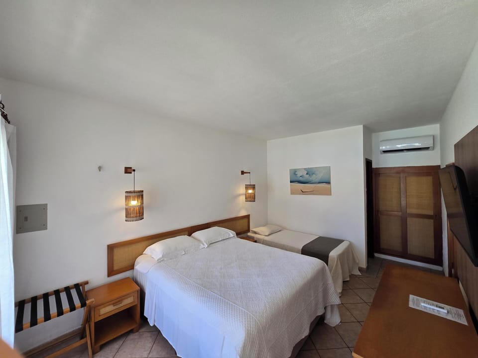 Triple Room, Pool View | In-room safe, blackout drapes, bed sheets