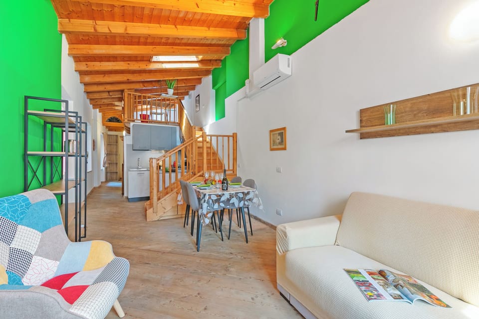 Family Apartment, Multiple Bedrooms (Nido dell'Usignolo) | Living area | 21-inch Smart TV with cable channels
