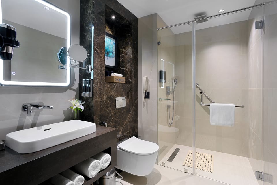 Suite, 1 King Bed | Bathroom | Shower, rainfall showerhead, hair dryer, bathrobes