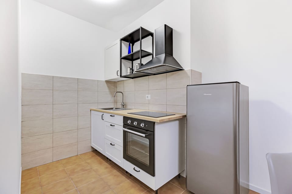 Comfort Apartment | Private kitchen | Espresso maker, electric kettle, cleaning supplies, freezer
