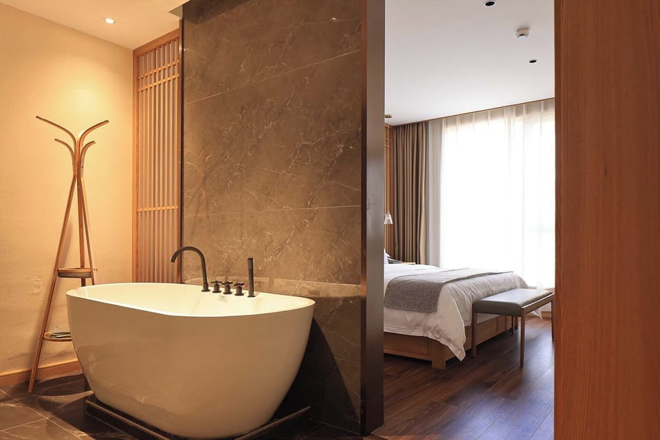 Executive Suite, Partial Lake View | Bathroom | Shower, free toiletries, hair dryer, slippers