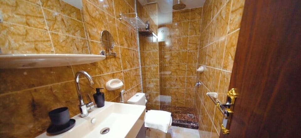 Shower, hair dryer, slippers, towels