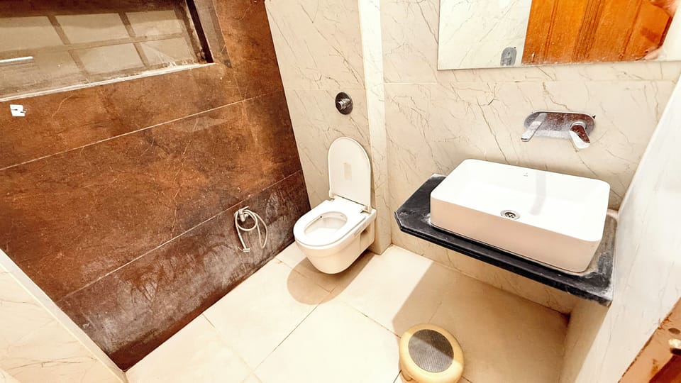 Shower, rainfall showerhead, soap, toilet paper
