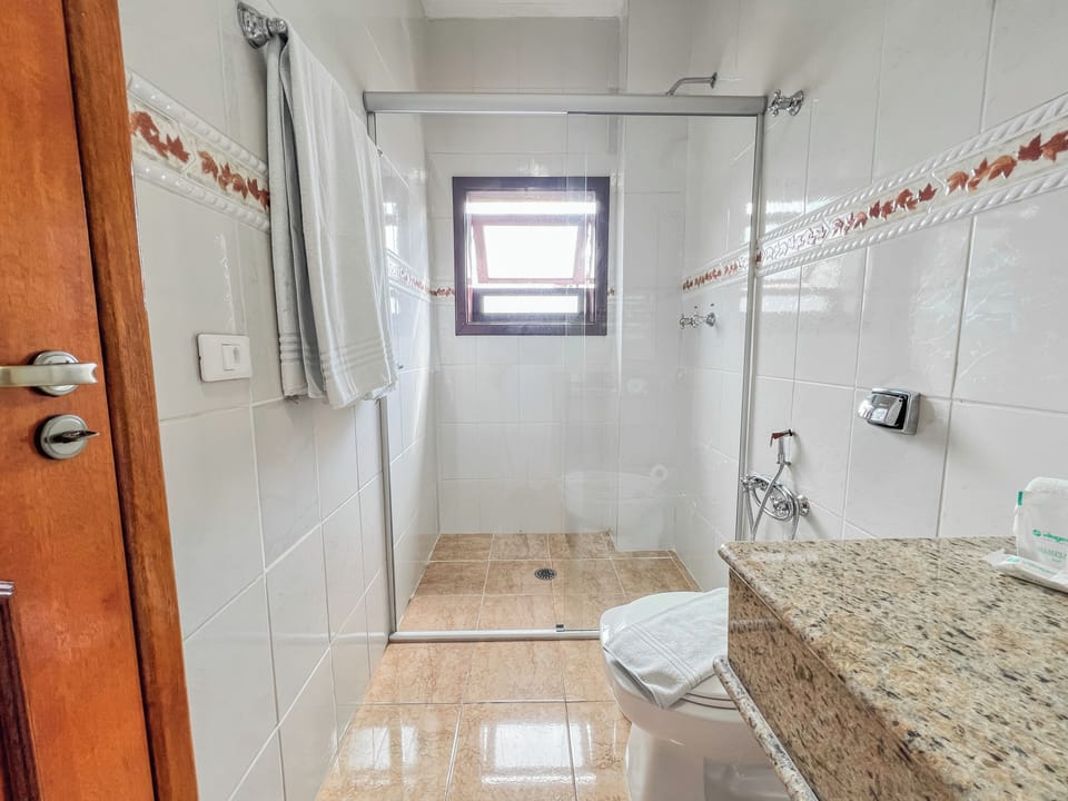 Shower, hair dryer, towels, toilet paper