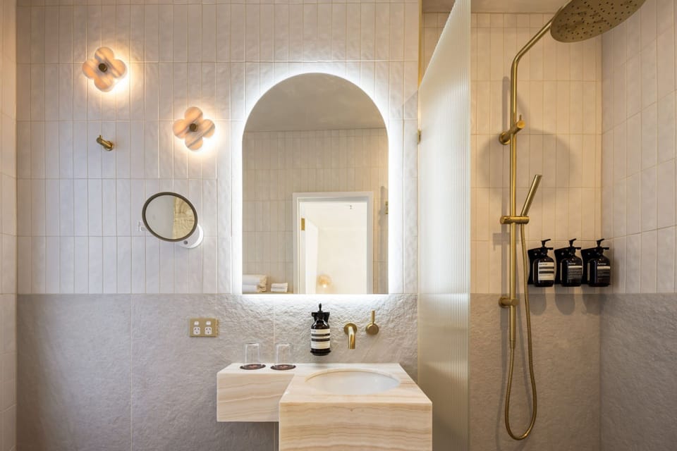 Deluxe Queen | Bathroom | Designer toiletries, hair dryer, towels, soap