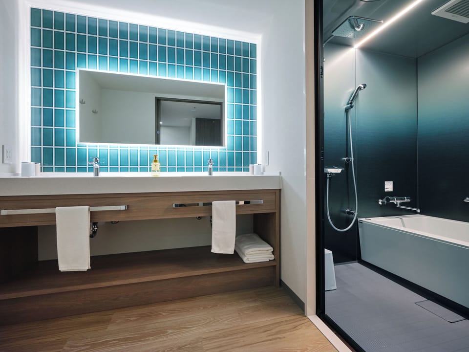 Premium Suite, Non Smoking | Bathroom | Combined shower/tub, free toiletries, hair dryer, slippers