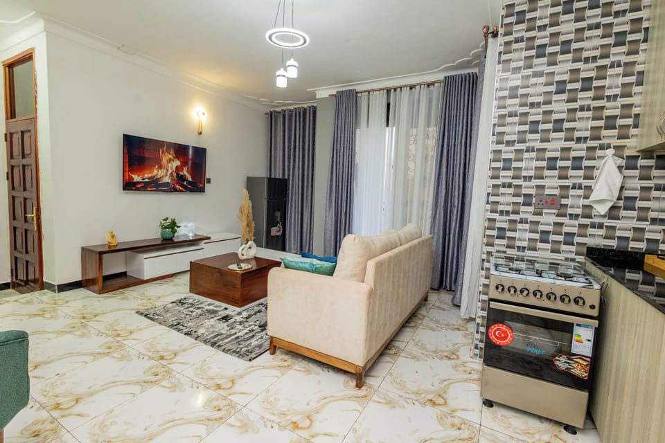Comfort Apartment, City View | Living area | 58-inch Smart TV with cable channels