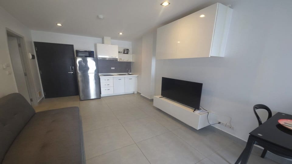 Apartment, Balcony, City View | Living area | Flat-screen TV