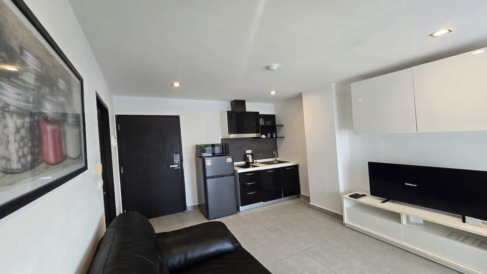 Apartment, Balcony, City View | Living area | Flat-screen TV