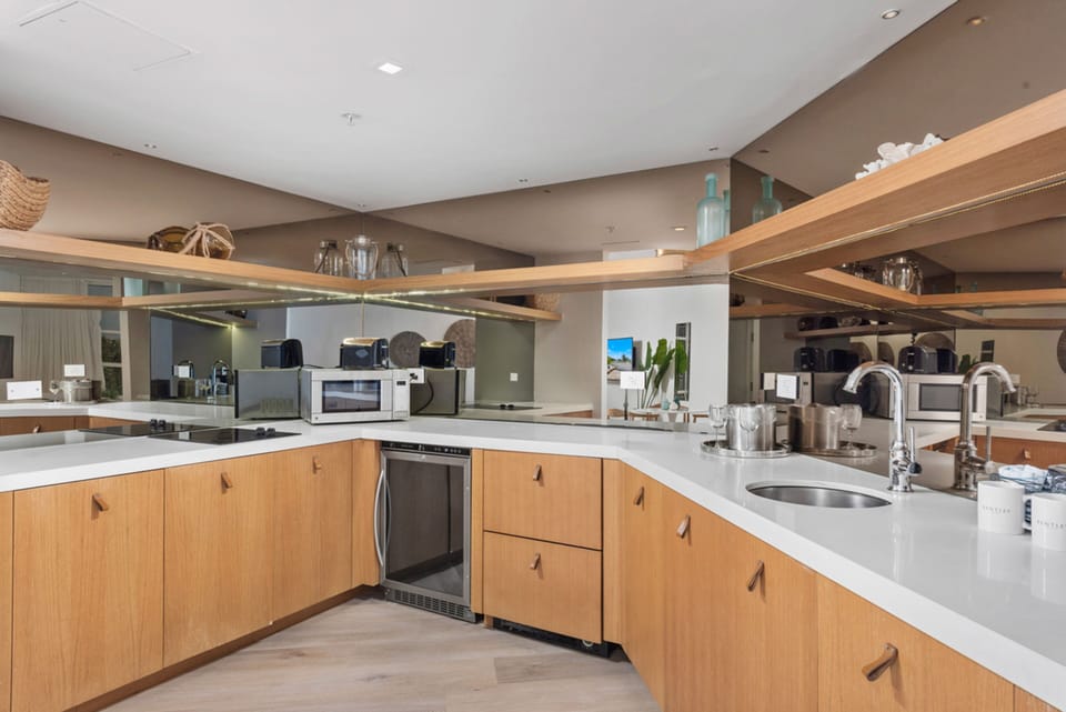 Coffee/tea maker, fridge, microwave, dining table