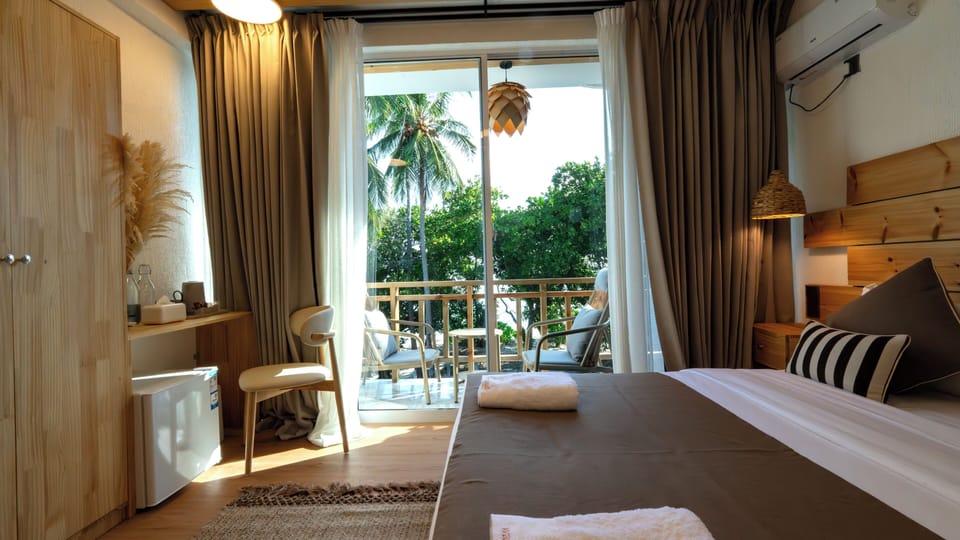 Deluxe Double or Twin Room, Balcony, Partial Sea View | Minibar, in-room safe, desk, laptop workspace
