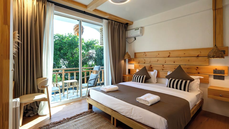 Deluxe Double or Twin Room, Balcony, Partial Sea View | Minibar, in-room safe, desk, laptop workspace