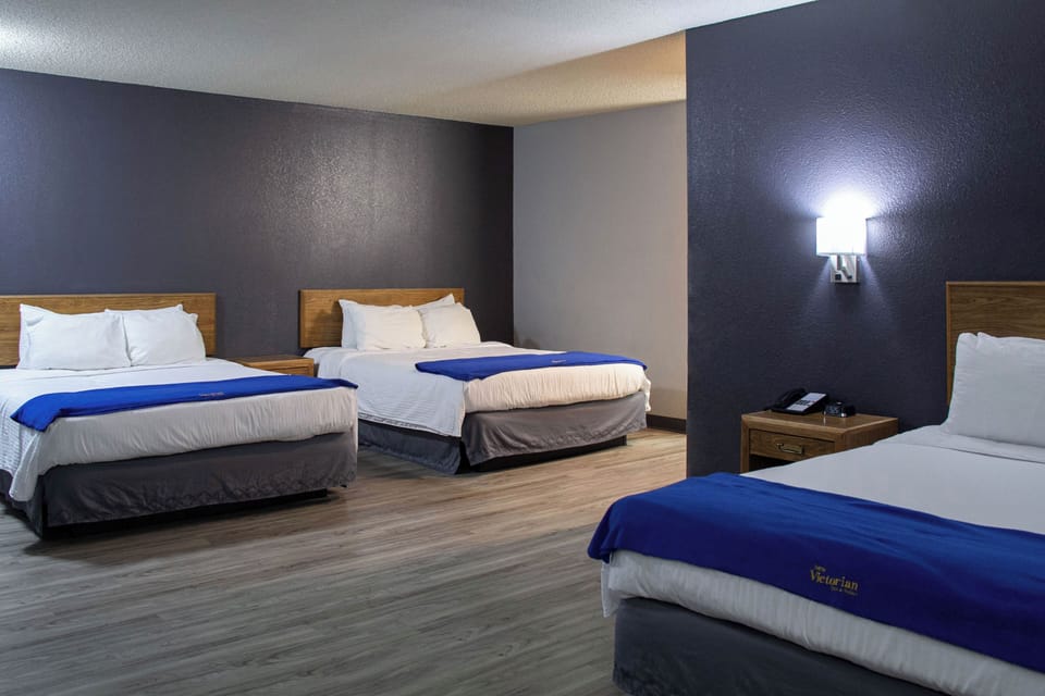 Suite, Multiple Beds | Desk, laptop workspace, blackout drapes, iron/ironing board