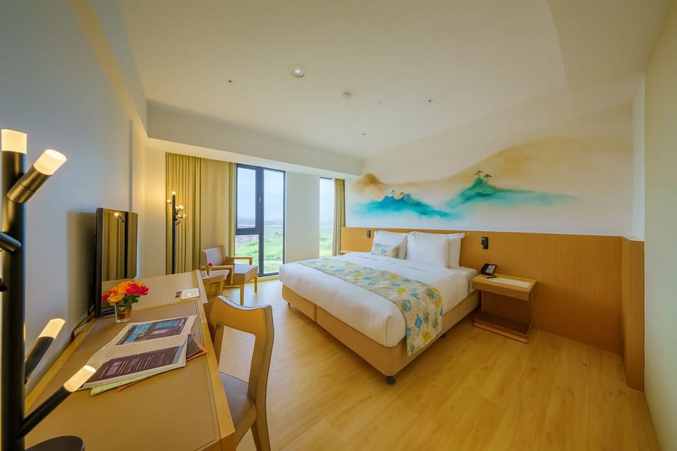 Deluxe Room, 1 King Bed | Down comforters, blackout drapes, WiFi (free), individually decorated