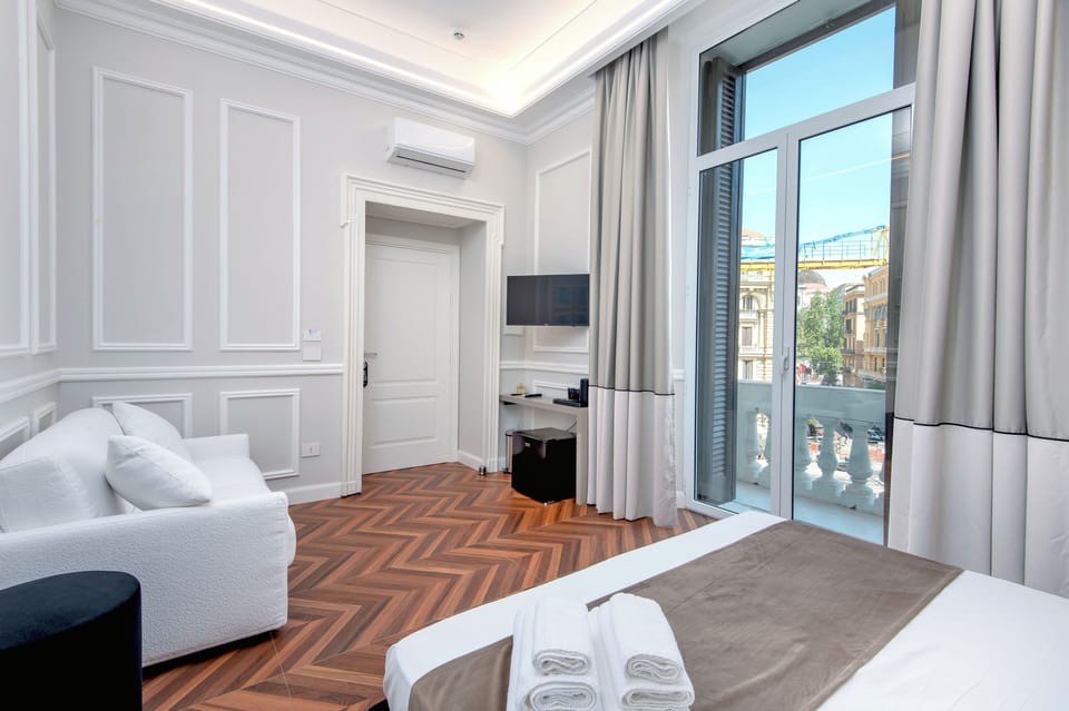 Exclusive Suite, Balcony, City View | Minibar, in-room safe, desk, laptop workspace