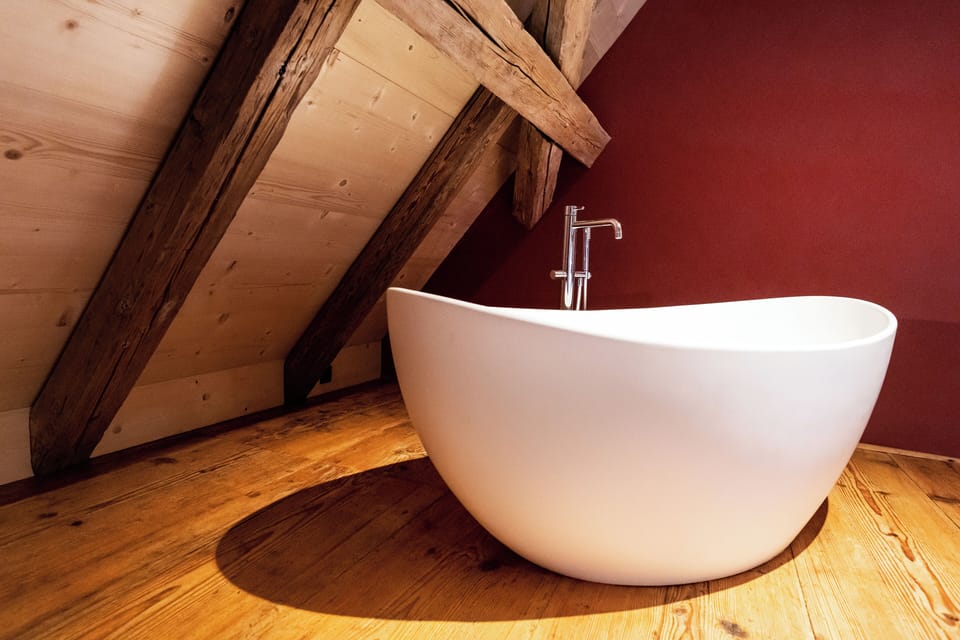 Suite | Bathroom | Shower, hair dryer, slippers, towels