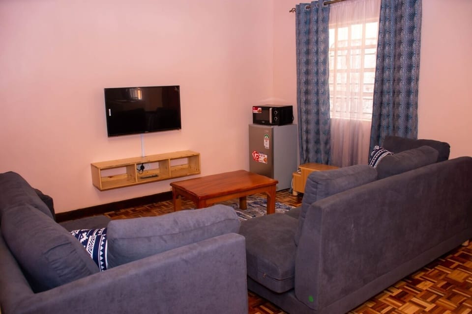 Deluxe Apartment | Living area | 32-inch Smart TV with digital channels