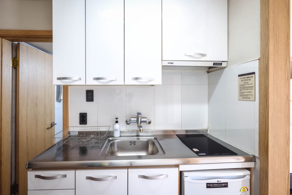 Full-size fridge, stovetop, rice cooker, cookware/dishes/utensils