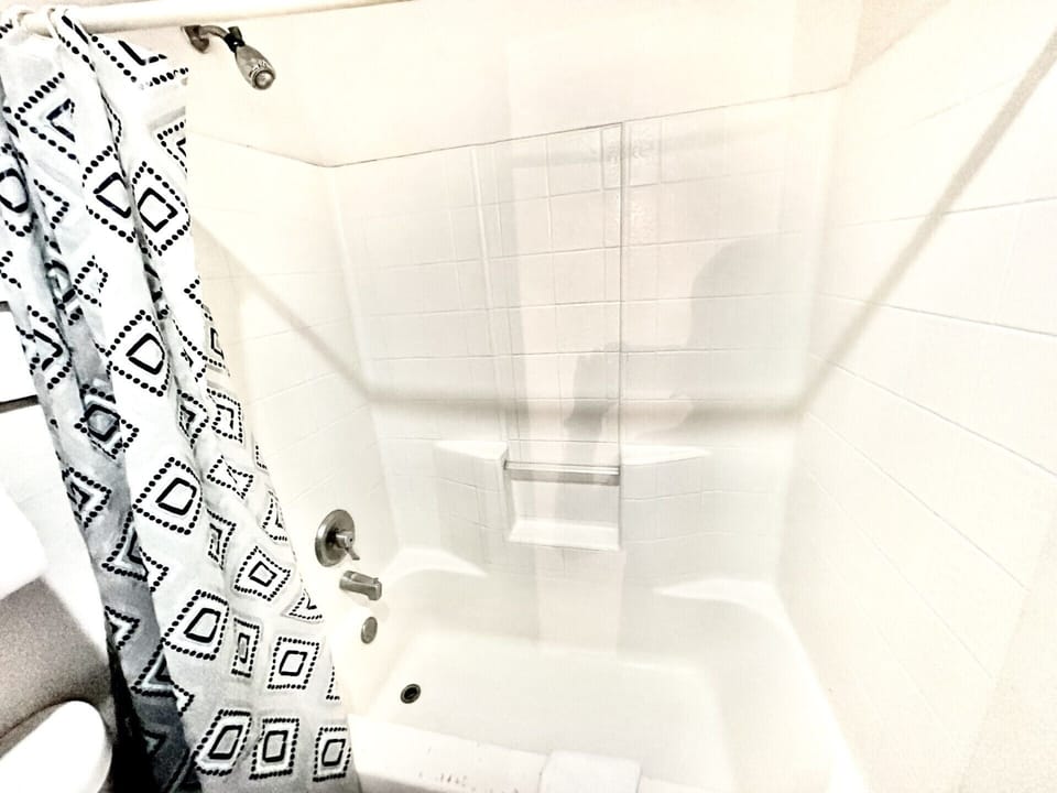 Separate tub and shower, towels, soap, shampoo
