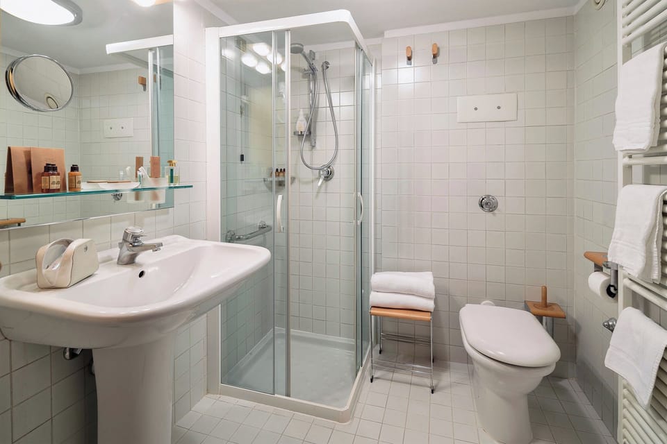 Shower, hair dryer, slippers, towels