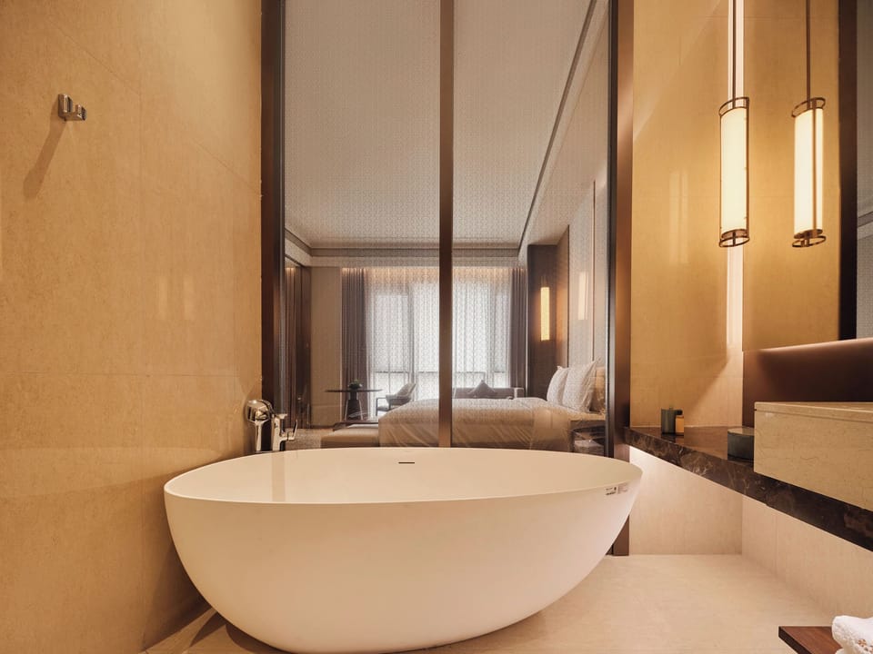Executive Suite King Bed Room | Bathroom | Designer toiletries, hair dryer, bathrobes, towels