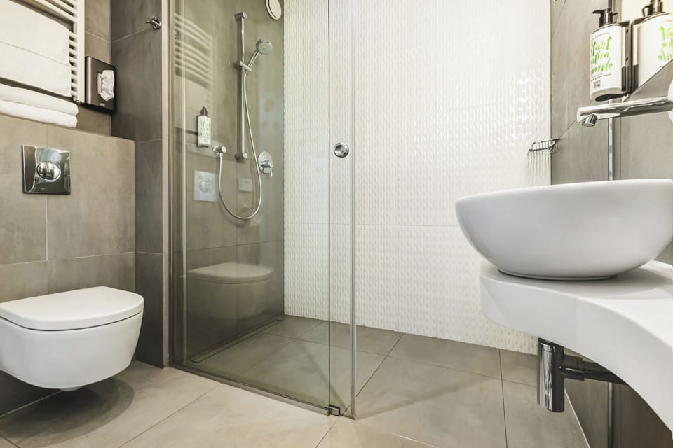 Shower, designer toiletries, hair dryer, towels