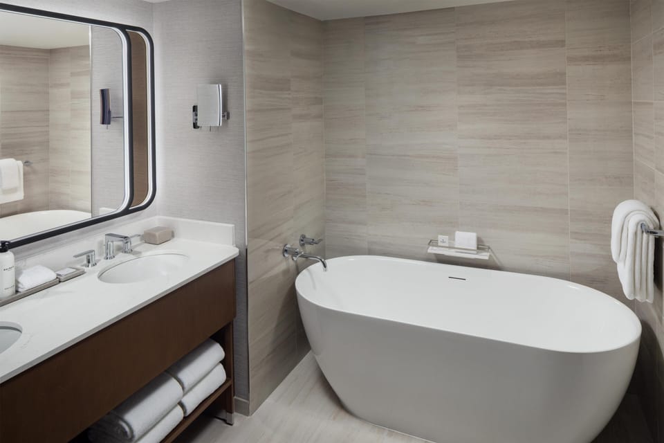 Separate tub and shower, designer toiletries, hair dryer, bathrobes