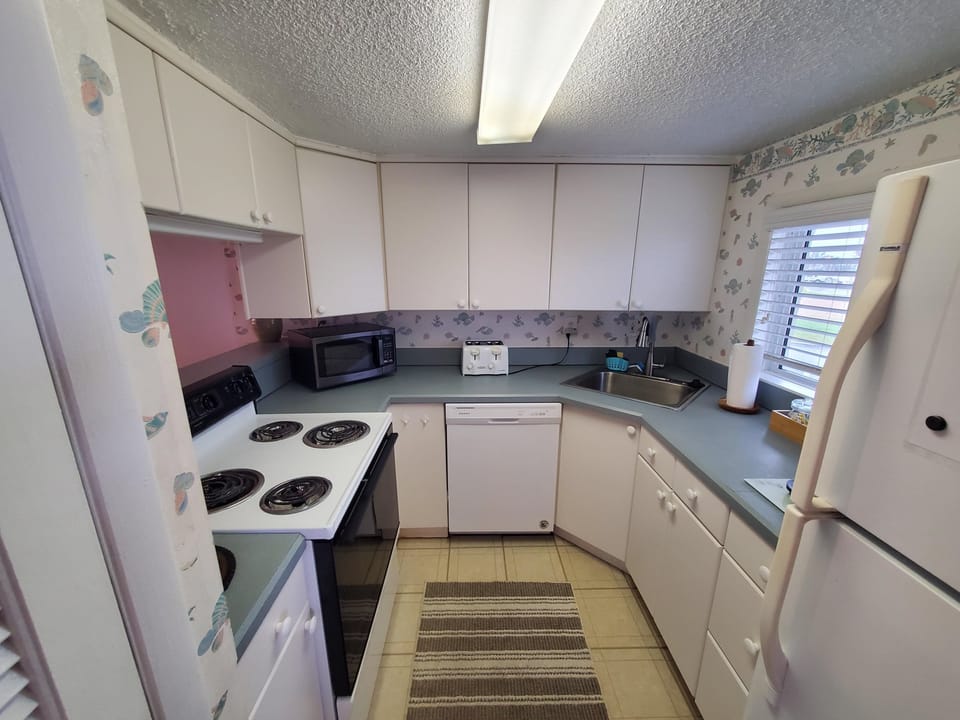 Condo, 1 King Bed with Sofa bed, Patio (Tradewinds 151) | Private kitchen | Dining tables