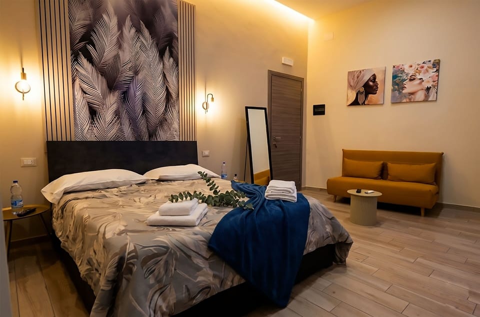 Deluxe Quadruple Room, Private Bathroom | Minibar (free items), in-room safe, blackout drapes, soundproofing