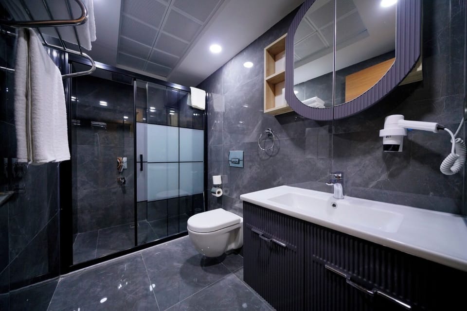 Shower, hair dryer, slippers, towels